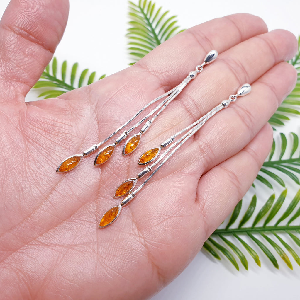 Toffee Amber Sterling Silver Long Cascading Stud Drop Earrings in a hand