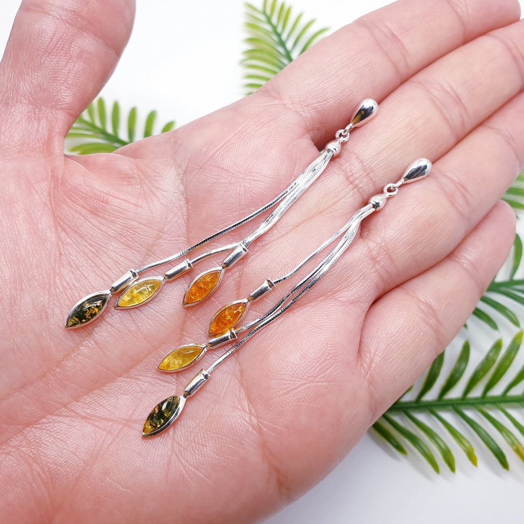 Mixed Amber Sterling Silver Long Cascading Stud Drop Earrings in a hand