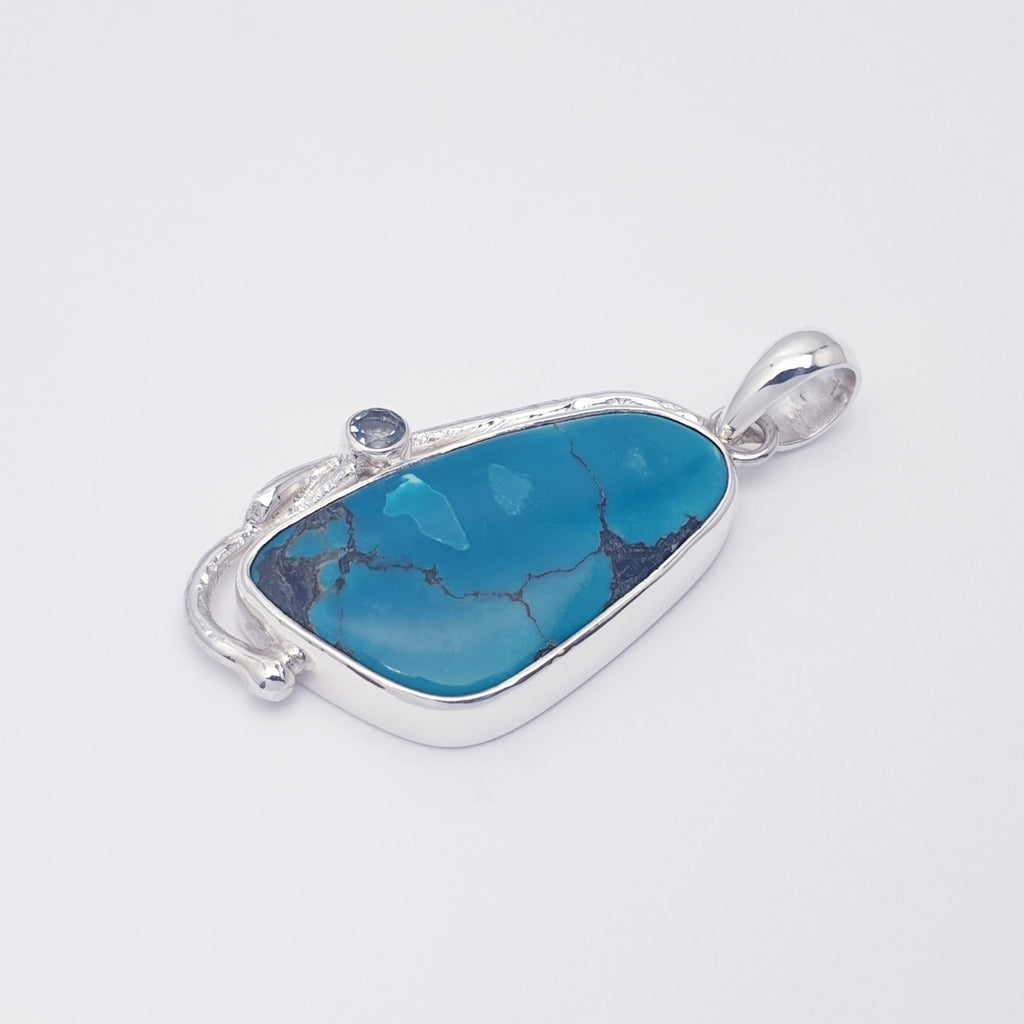 turquoise and blue topaz gemstone pendant with sterling silver botanical design