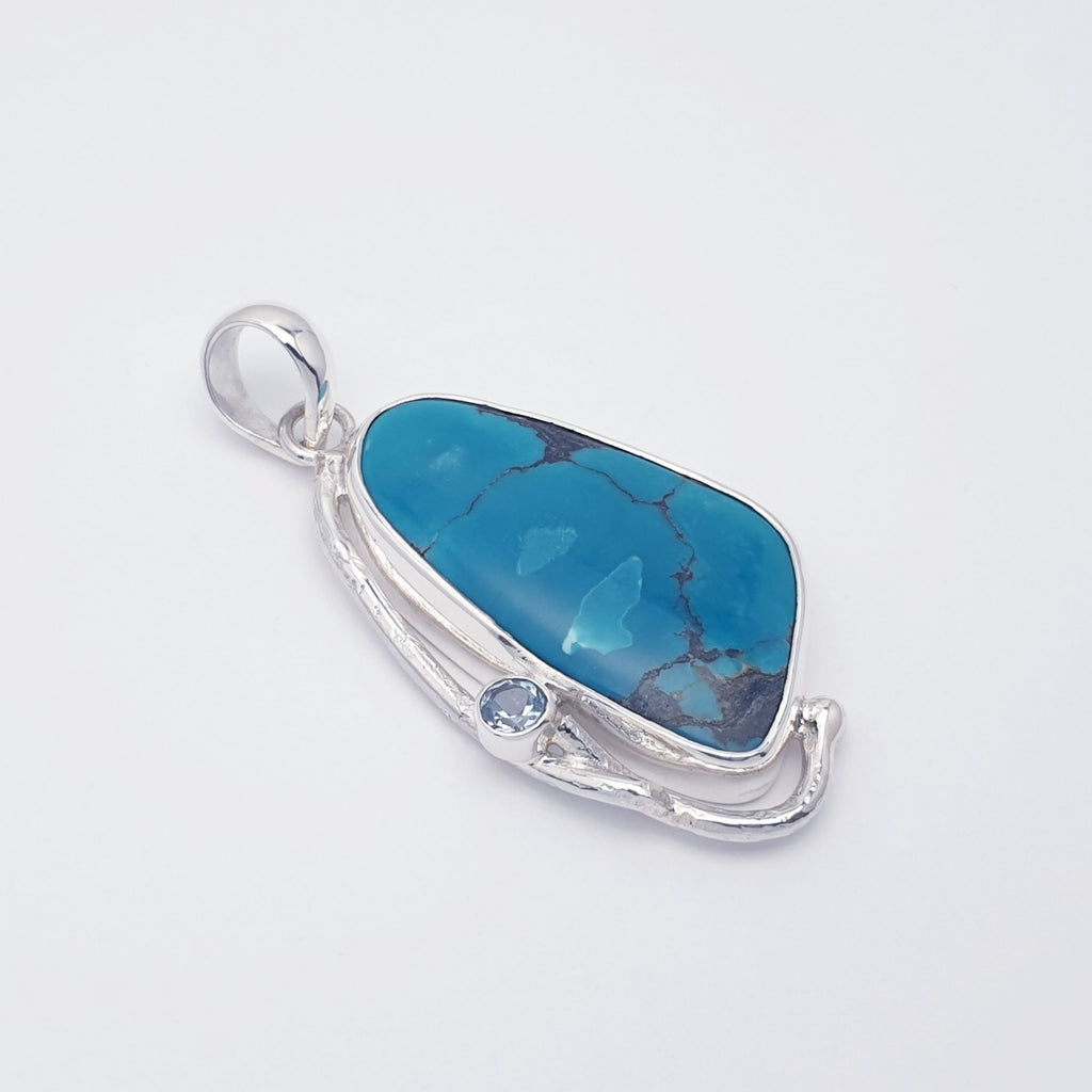 turquoise and blue topaz gemstone pendant with sterling silver botanical design