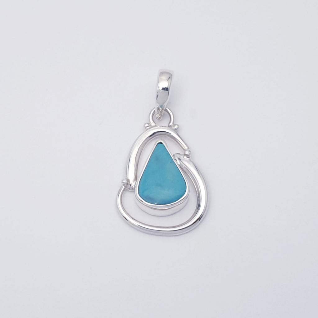 Handmade turquoise gemstone pendant with swirling sterling silver design