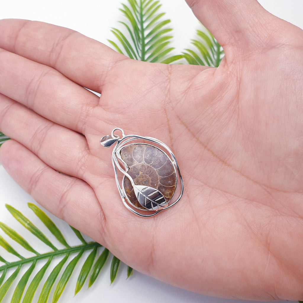 Ammonite fossil pendant with sterling silver leaf design