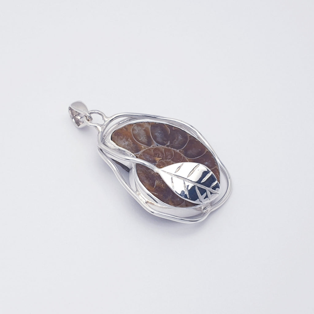 Ammonite fossil pendant with sterling silver leaf design