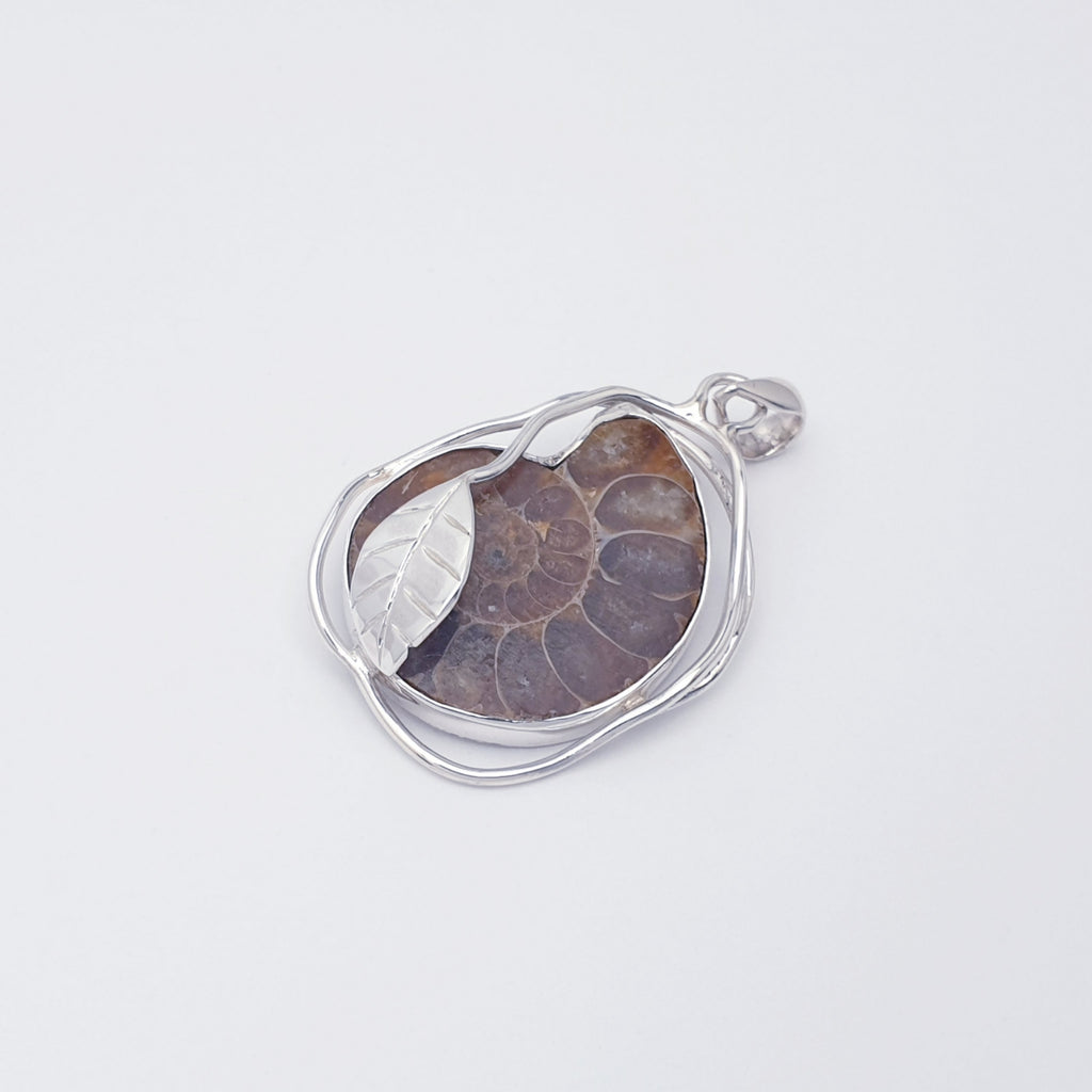 Ammonite fossil pendant with sterling silver leaf design