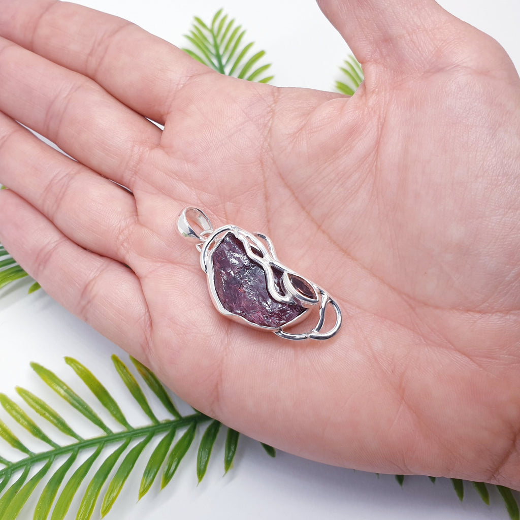 Raw garnet pendant with sterling silver vine design