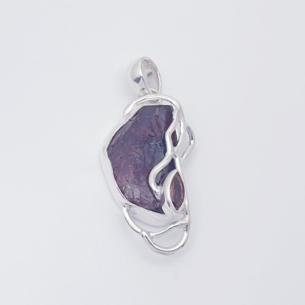 Raw garnet pendant with sterling silver vine design