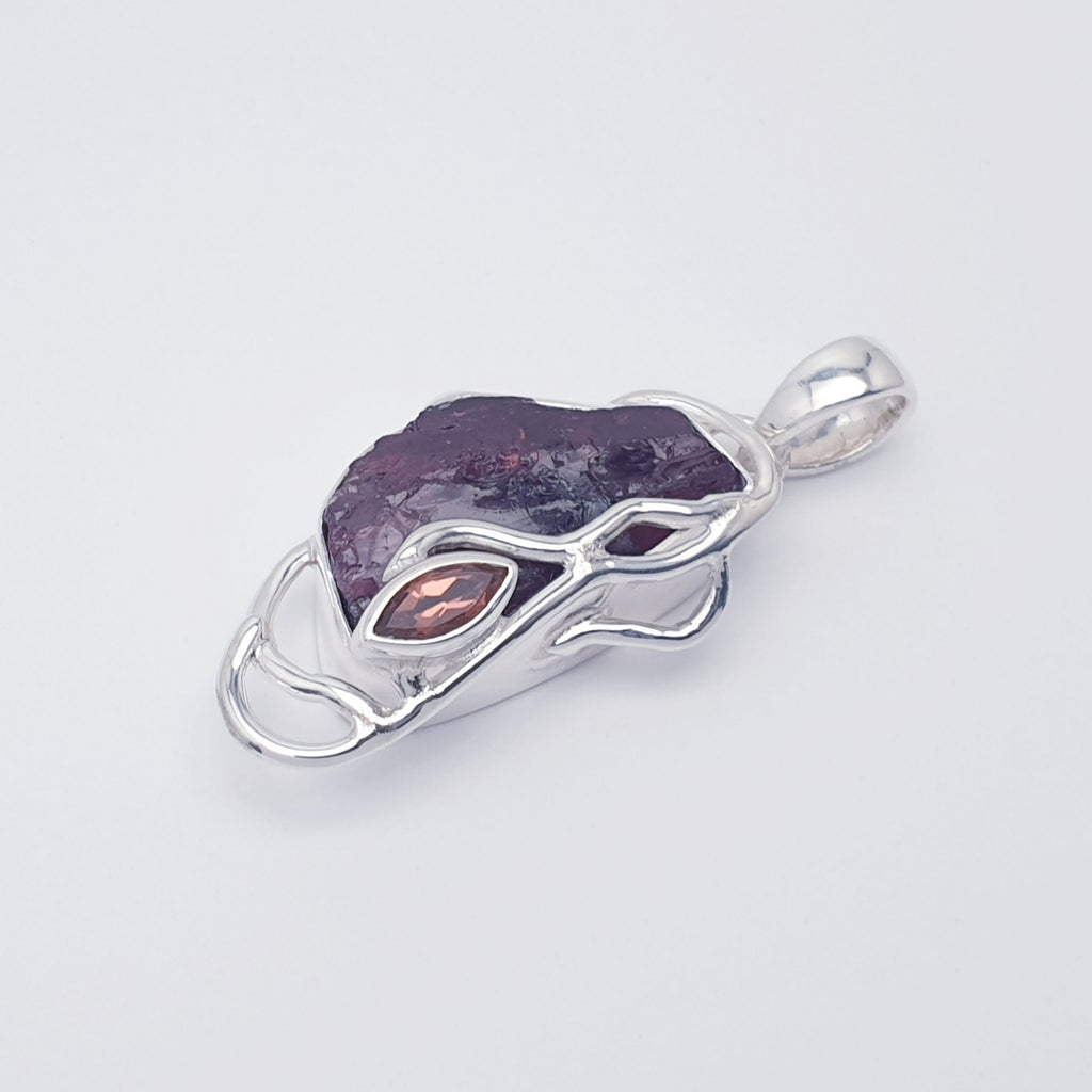 Raw garnet pendant with sterling silver vine design