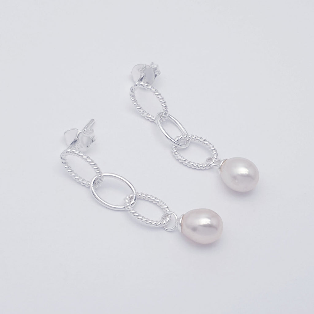 sterling silver and pearl stud earrings.