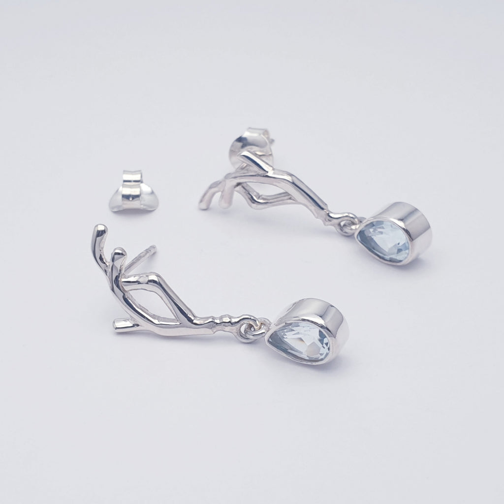 Our blue topaz vine earring displayed on a white background