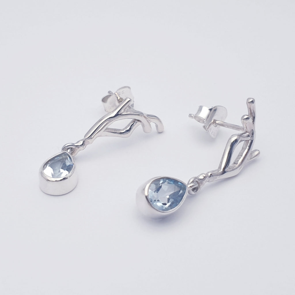 Our blue topaz vine earring displayed on a white background