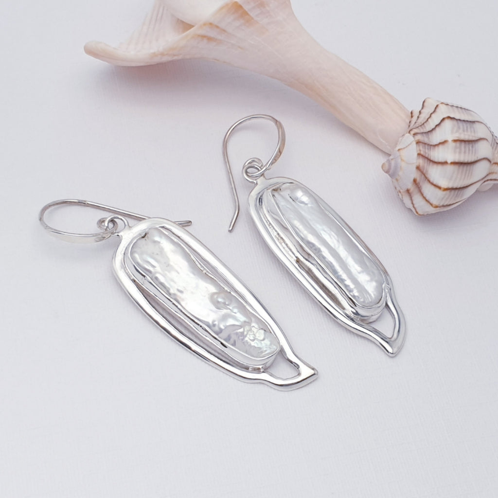 One-off keshi pearl earrings on a white background with shell details