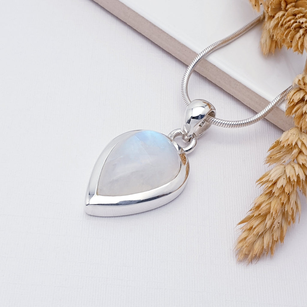 Sterling Silver Moonstone Simple Teardrop Pendant on a white background with barley on the right hand side. The pendant is paired with a medium snake chain.