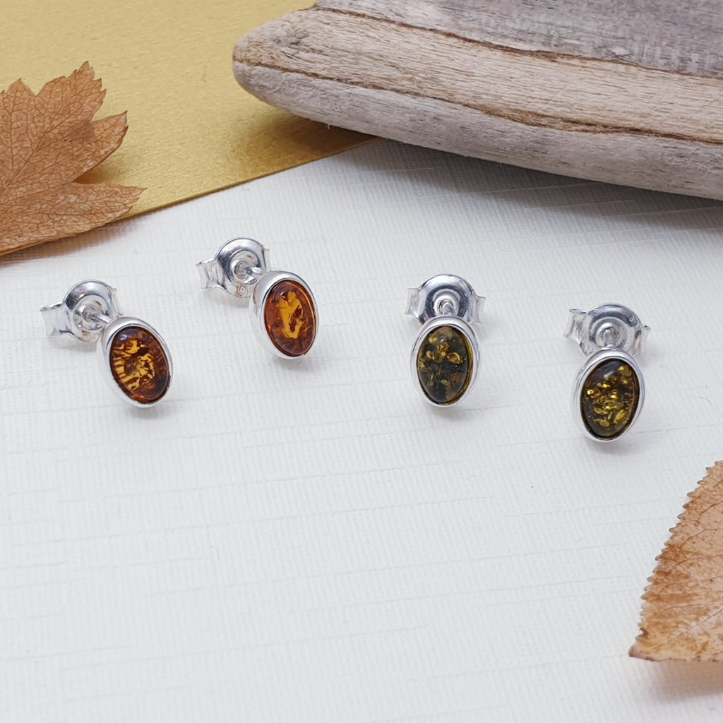Toffee and green amber sterling silver stud earrings with autumn foliage.