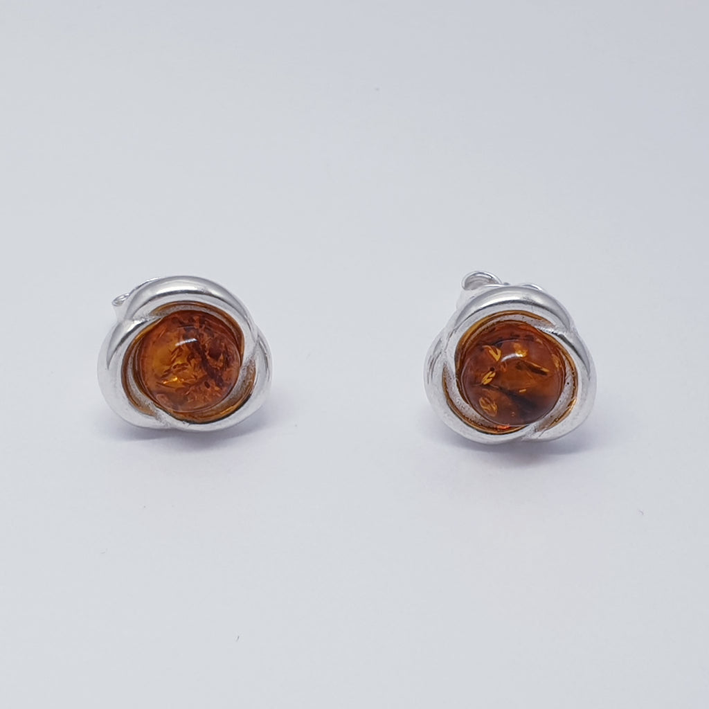 A pair of amber and sterling silver stud earrings.
