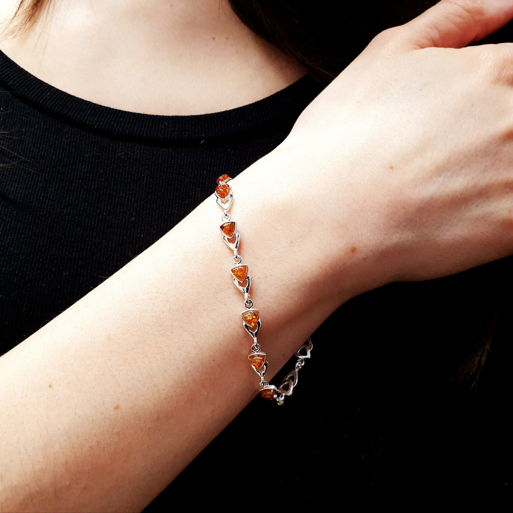 A model wearing a Toffee amber sterling silver bracelet.