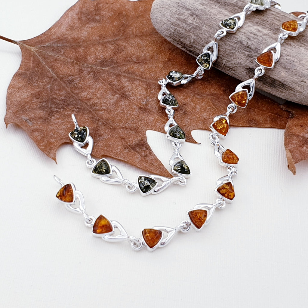Toffee and green amber sterling silver bracelets with autumn foliage.