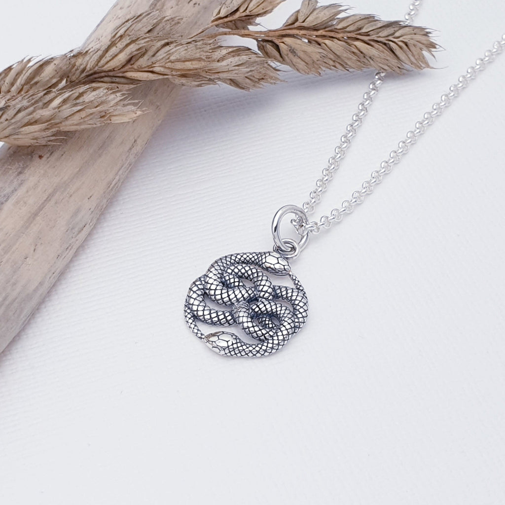 This pendant features two beautiful, detailed snakes with an oxidised finish, giving it depth and presence. 