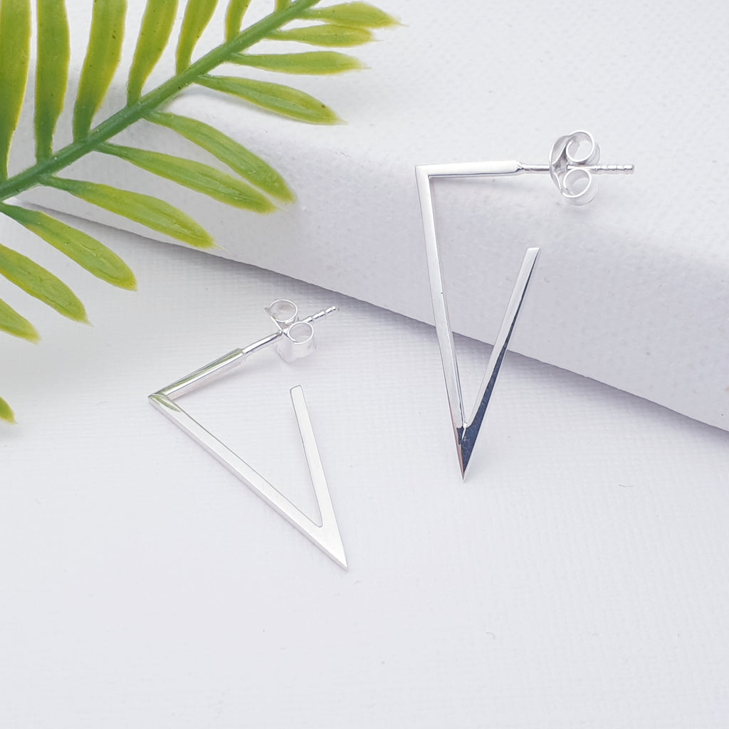 This design features Silver acute triangle hoops, ideal for work or day wear. The stud fixing makes these earrings extra secure so you don't need to worry about losing them