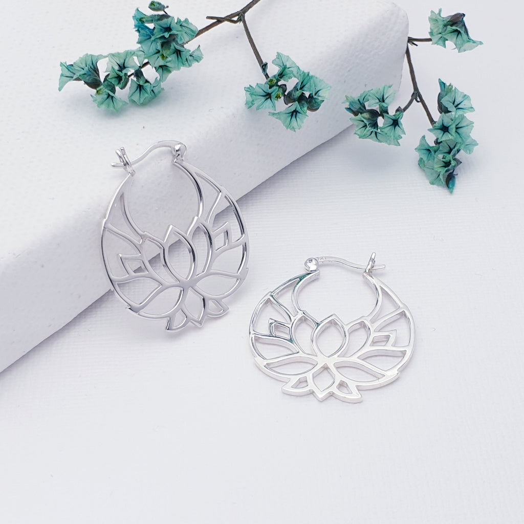 These earrings feature a beautiful intricate cut out lotus flower design. These earrings are perfect for your next holiday or to add a touch of tropical vibe to any outfit.