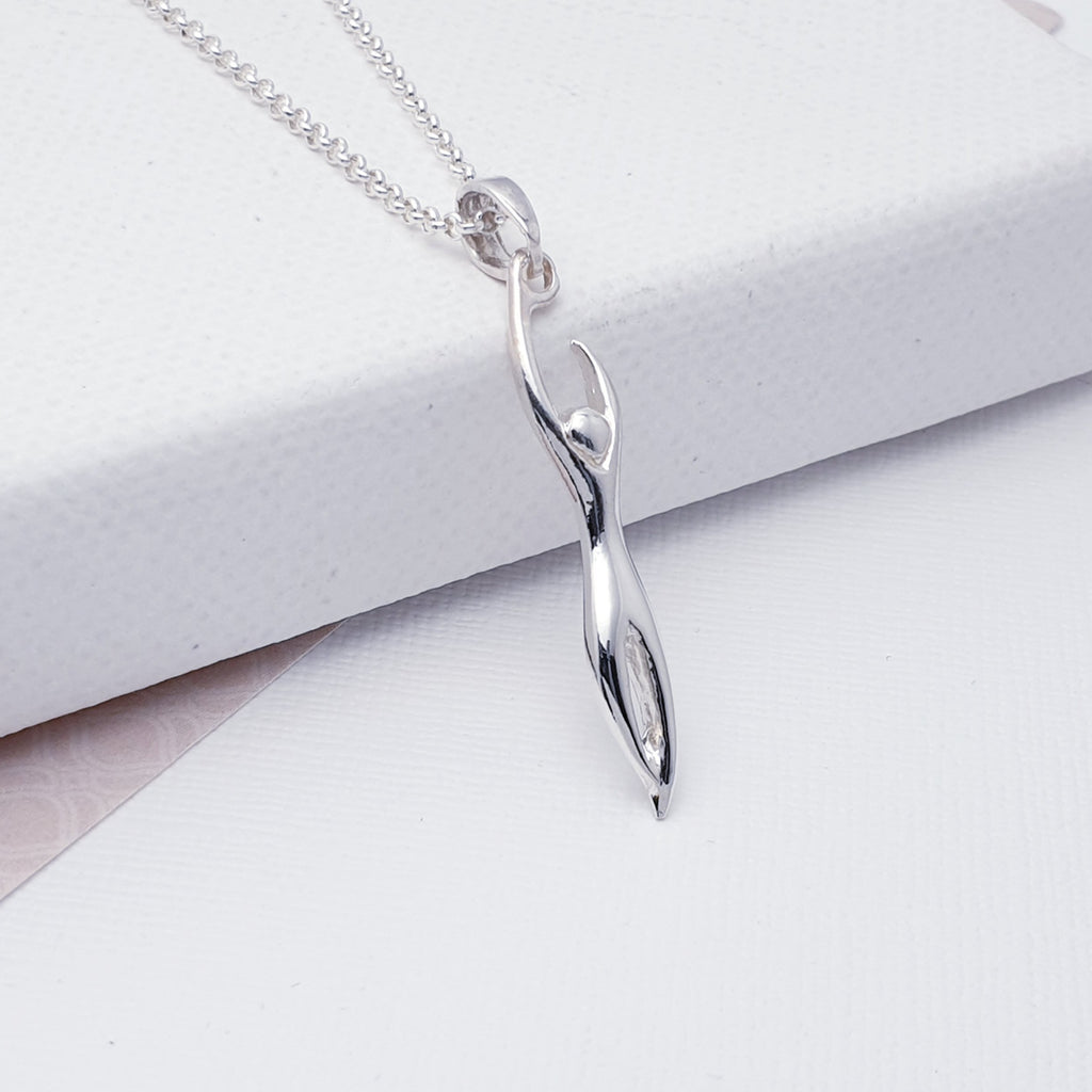 This pendant features a Silver silhouette of a figure stretching, a perfect unisex pendant to complement any outfit.