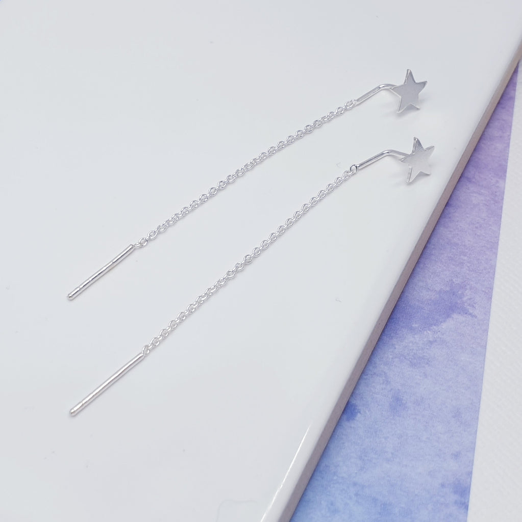 With a pull through chain that give these earrings a unique look and a touch of elegance, these dynamically different earrings are sure to catch the eye. The small flat star finishes the design off perfectly.