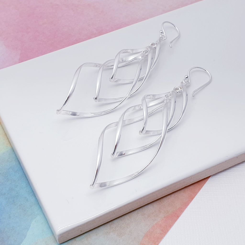 With a contemporary design these earrings have taken inspiration from three Silver teardrop shapes that delicately hang from the top of the earring. Our Large Staggered Teardrop Earrings will frame your face perfectly and add a touch of sophistication to any outfit.