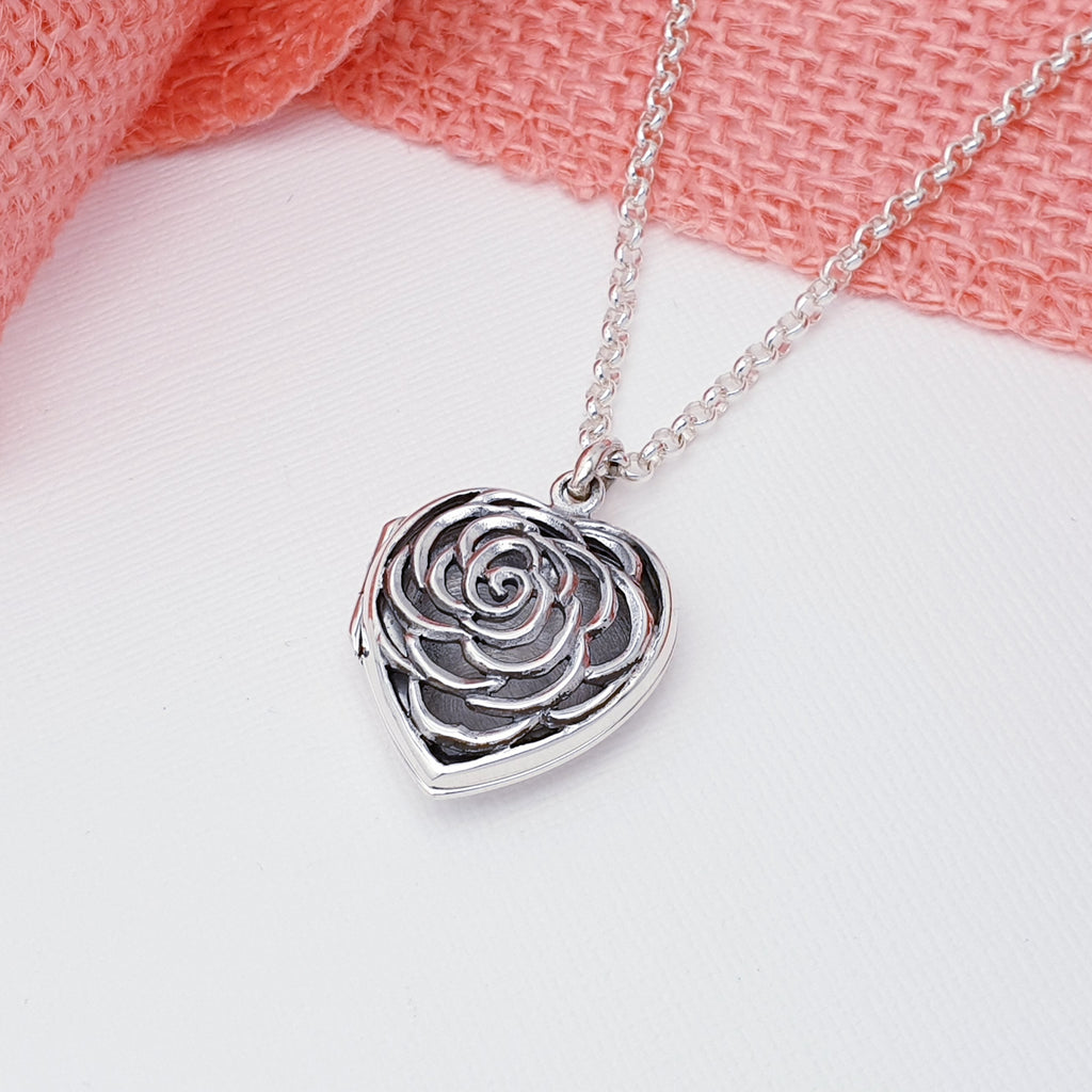 This silver locket has a gorgeous cut out rose flower design on the front, that sets it apart from the traditional heart locket. 