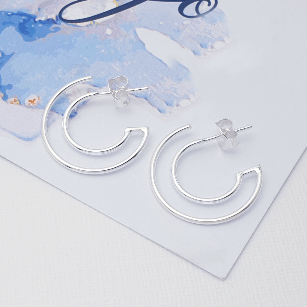 Each earring features a cut out Sterling Silver hoop design. When worn it gives the illusion of two piercings. An unusual and eye-catching pair of hoops, these will complement any outfit or style. The stud fixing makes these earrings extra secure so you don't need to worry about losing them.