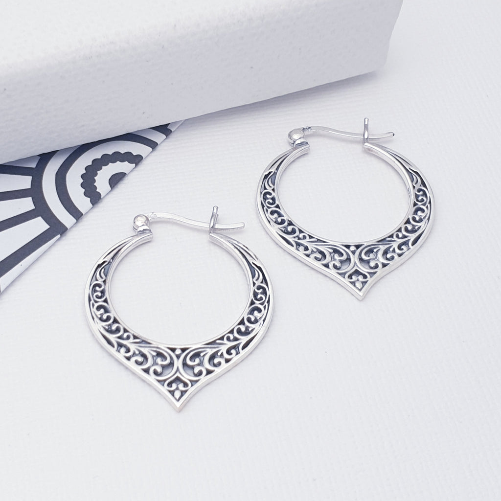These Sterling Silver hoops feature a beautiful, intricate, cut out swirl design. A gorgeous oxidised finish, adds depth and presence to these adorable hoops. This enhances the Art Nouveau style and are perfect for your next summer festival or holiday.