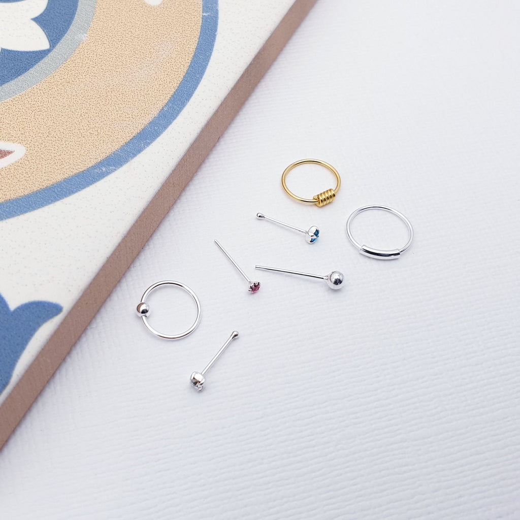 These nose stud and ring packs are a jewelry lover's dream! With twenty unique and stylish options, there's something for everyone! Mix and match for maximum sass, or keep it classic with a subtle sparkle. Your nose will thank you for all the attention!   Perfect as a gift for a loved one or a little treat for yourself.