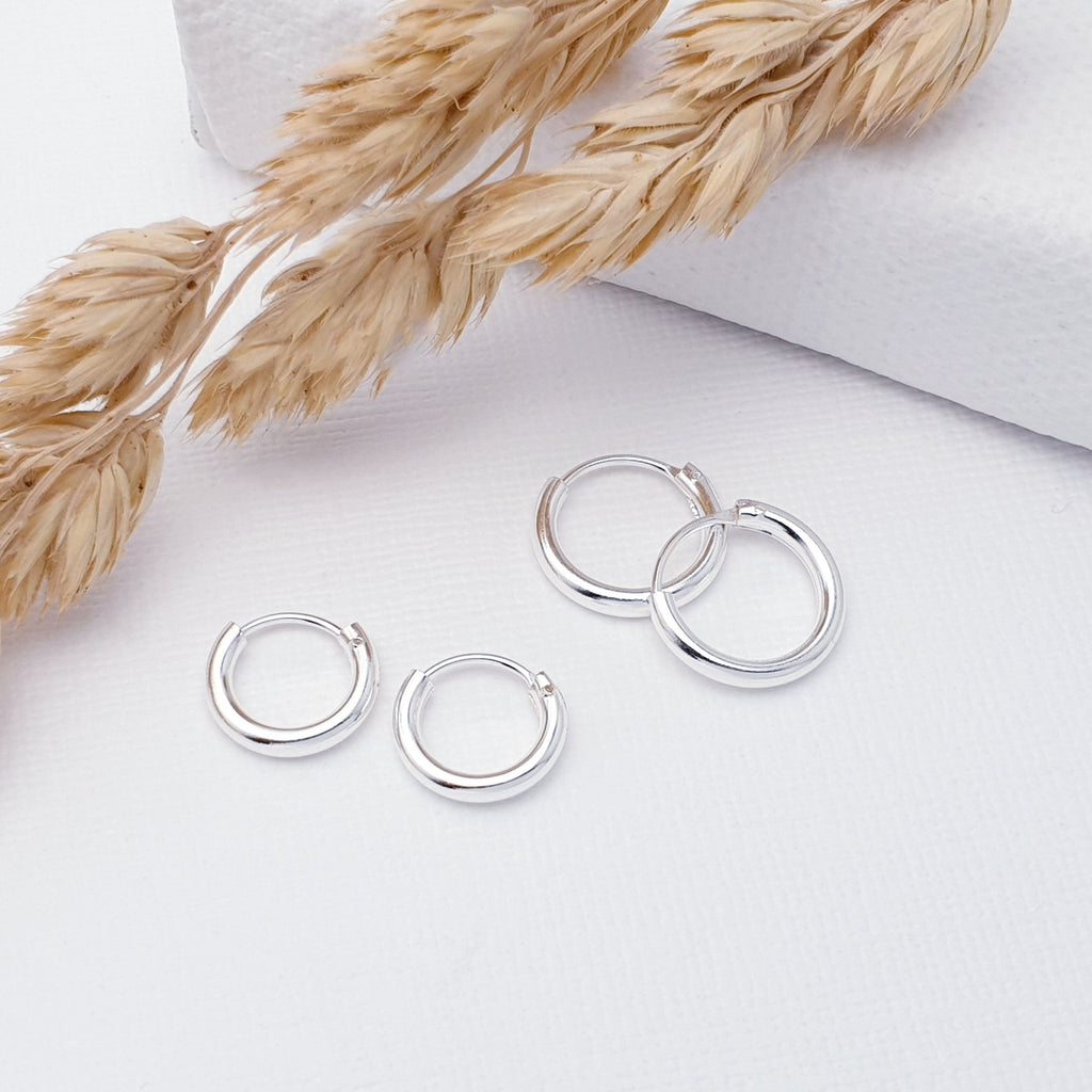 Our Sterling Silver Sleeper Hoops Double Pack (1cm and 1.2cm) are ideal for everyday wear and can transition effortlessly from work to play.  Plain silver hoops have always been popular in our shops and they are a must have in any jewellery box collection. They can be a little tricky to get in (especially smaller sizes), but once in, you can forget about them as they are very unlikely to come out and get lost. Comfortable to wear and light on the ear, they are the perfect everyday wearers. 