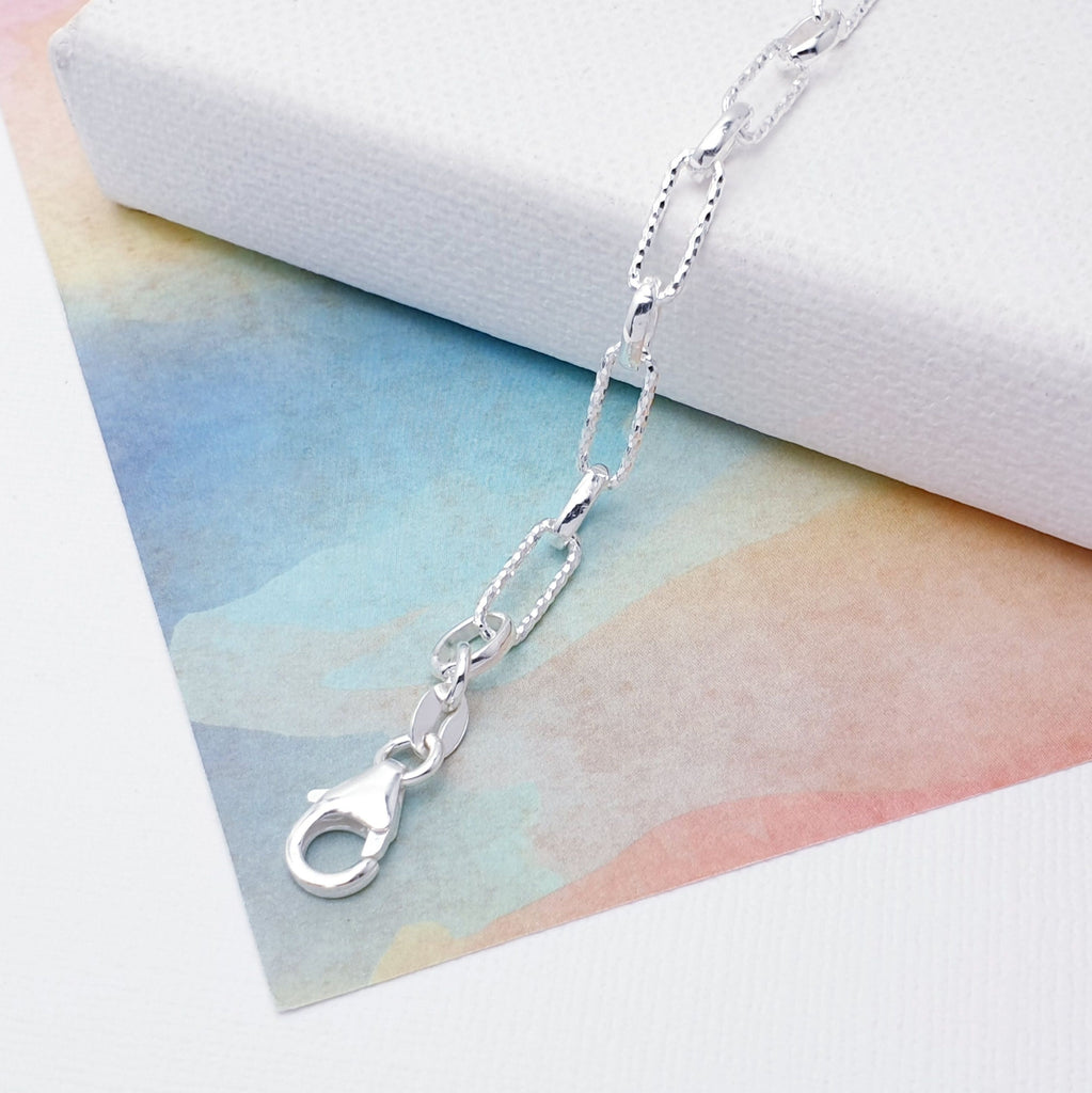 Our beautiful Sterling Silver Hammered and Polished Combo Paperclip Link Bracelet is perfect for everyday wear or special occasions.  This design features both hammered and polished oval links that are connected in a paperclip pattern, creating a beautiful and stylish design. 