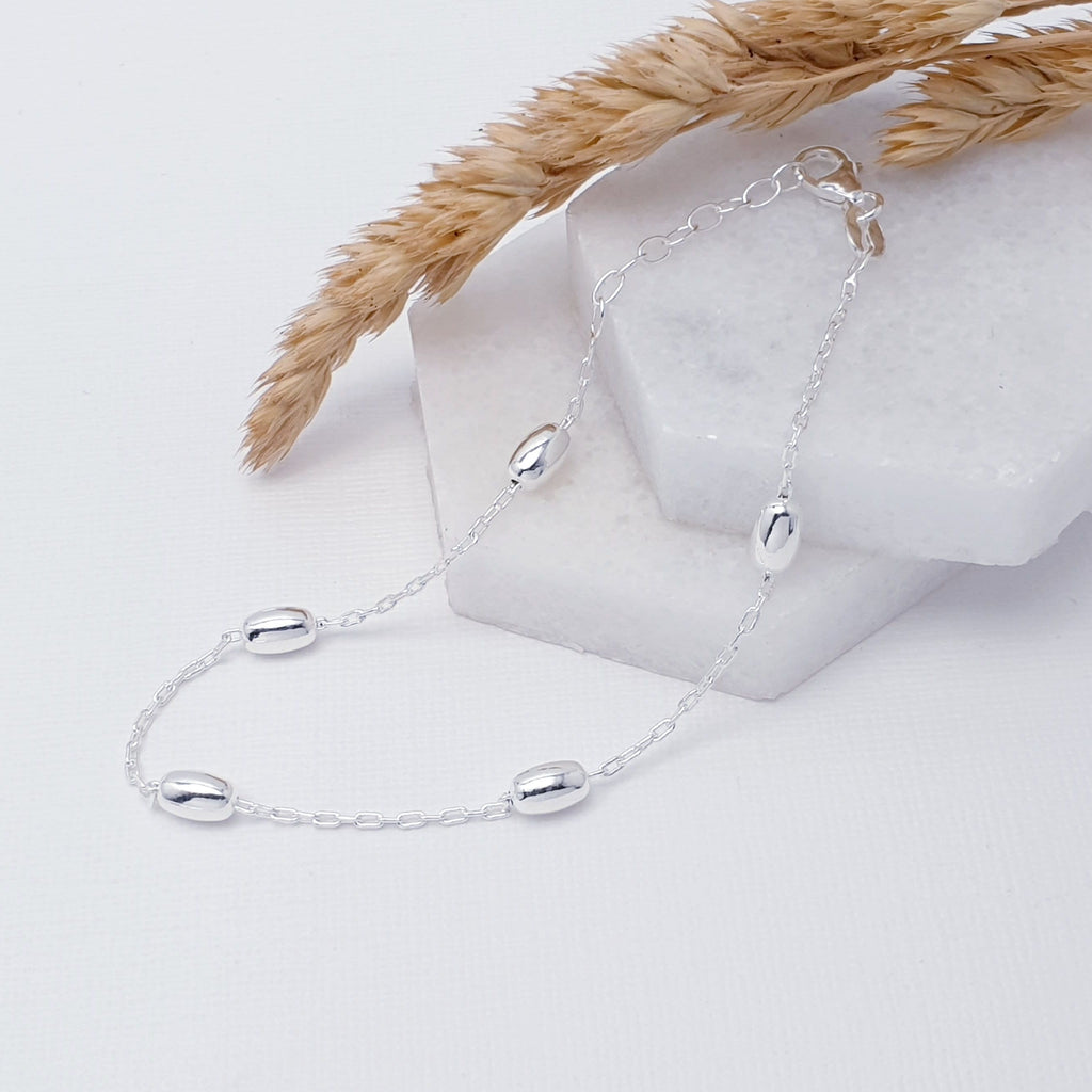 Our Sterling Silver Oval Bead Bracelet is perfect for everyday wear.  The design features five Sterling Silver oval beads on a fine chain, making it an elegant and dainty bracelet.  An adjustable chain on the end means that this bracelet can fit different wrist sizes, giving you piece of mind when buying it as a gift.