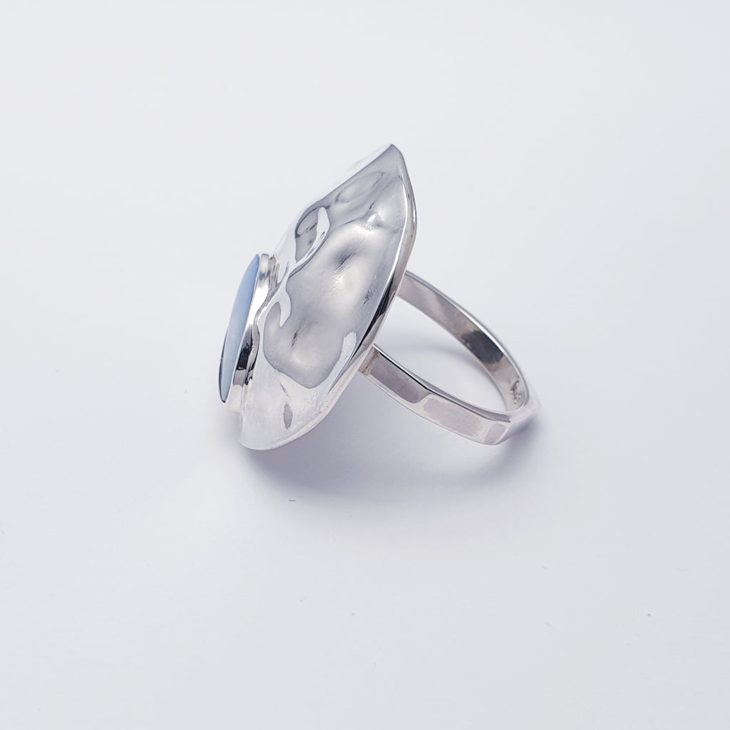 A beautiful design, this ring features a gorgeous free form Australian Opal doublet set in a Sterling Silver hammered circle.  A super statement ring perfect for adding a little sparkle to any outfit or occasion.