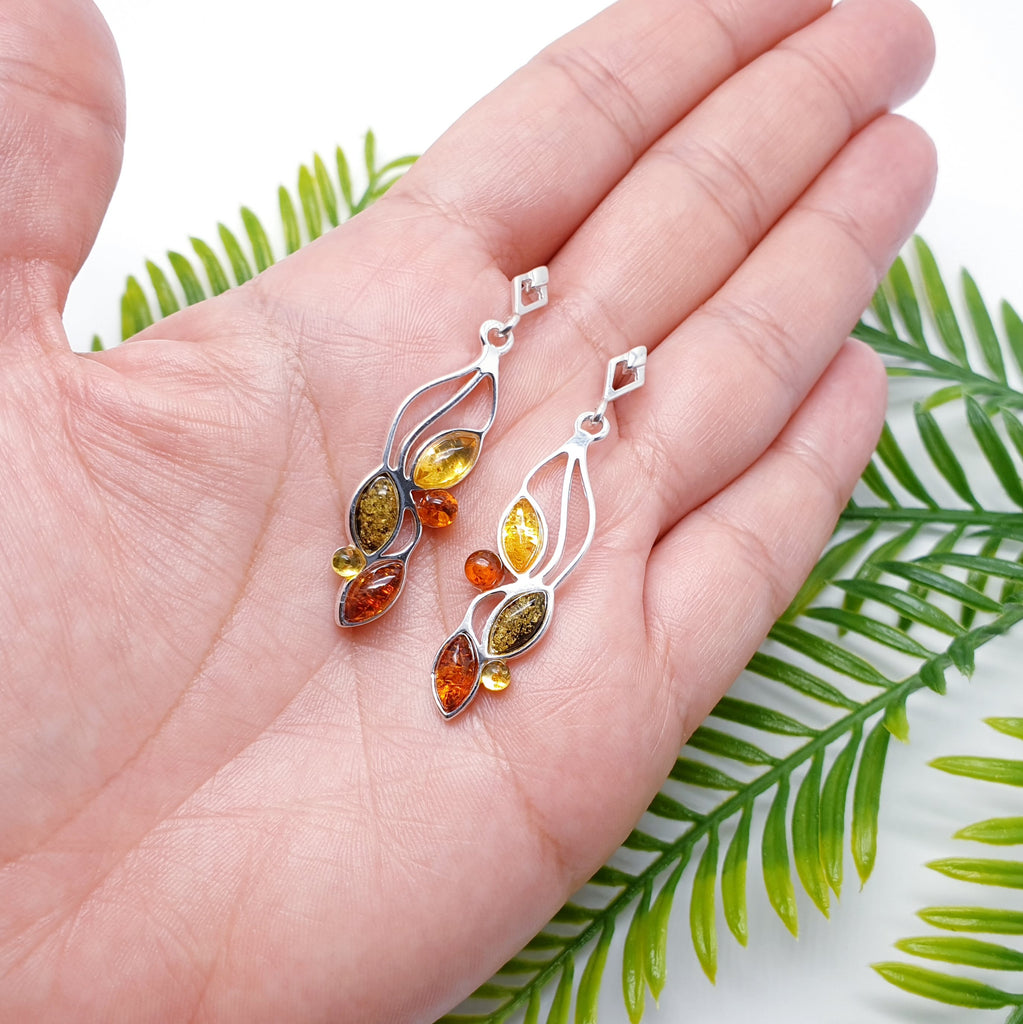 Each earring features three marquise shaped, and two small round mixed Amber Stones. Each stone represents a little leaf on a Sterling Silver hanging vine. This beautiful nature inspired design uses the finest Baltic amber. The Sterling Silver stud fixing make these earrings extra secure so you won't need to worry about loosing them. 