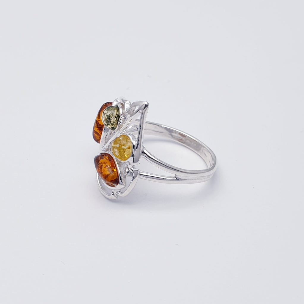 This ring features two marquise shaped Toffee Baltic Amber stone and two smaller round mixed Amber stones in simple settings. Inspired by nature, Sterling silver leaf detailing has been added around the amber stone to accentuate the shape. A fine sterling silver band finishes off this design perfectly.