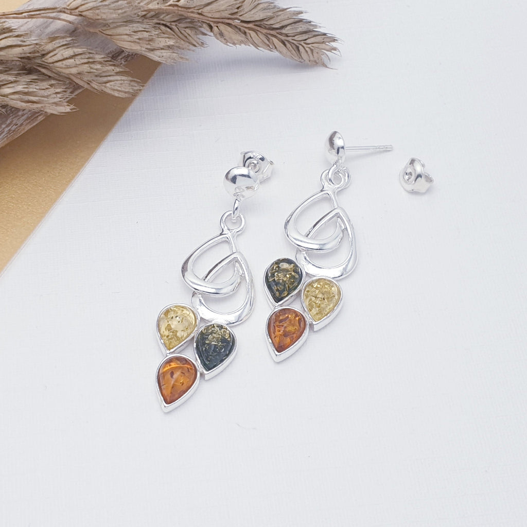 Each earring features three teardrop shaped, yellow, green and Toffee Amber Stones. Each stone represents fruit hanging from a Sterling Silver little leaf. This beautiful nature inspired design uses the finest Baltic amber. The Sterling Silver stud fixing makes these earrings extra secure so you won't need to worry about loosing them. 