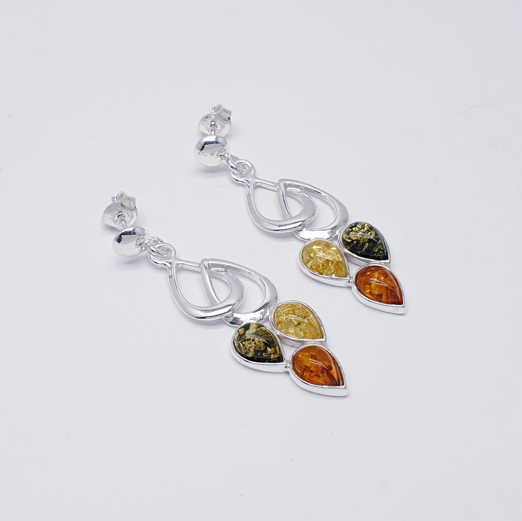 Each earring features three teardrop shaped, yellow, green and Toffee Amber Stones. Each stone represents fruit hanging from a Sterling Silver little leaf. This beautiful nature inspired design uses the finest Baltic amber. The Sterling Silver stud fixing makes these earrings extra secure so you won't need to worry about loosing them. 