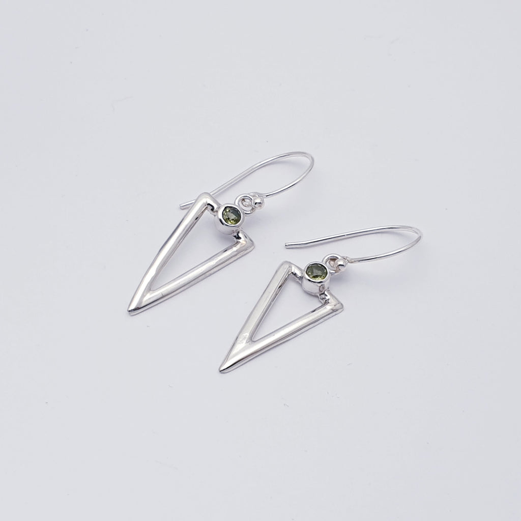 A simple yet unique design, these earrings feature round tabletop cut Peridot stones, which sit above acute triangles hand worked in Sterling Silver. Light, easy to wear and will complement any outfit, these earrings will soon become everyday favourites.