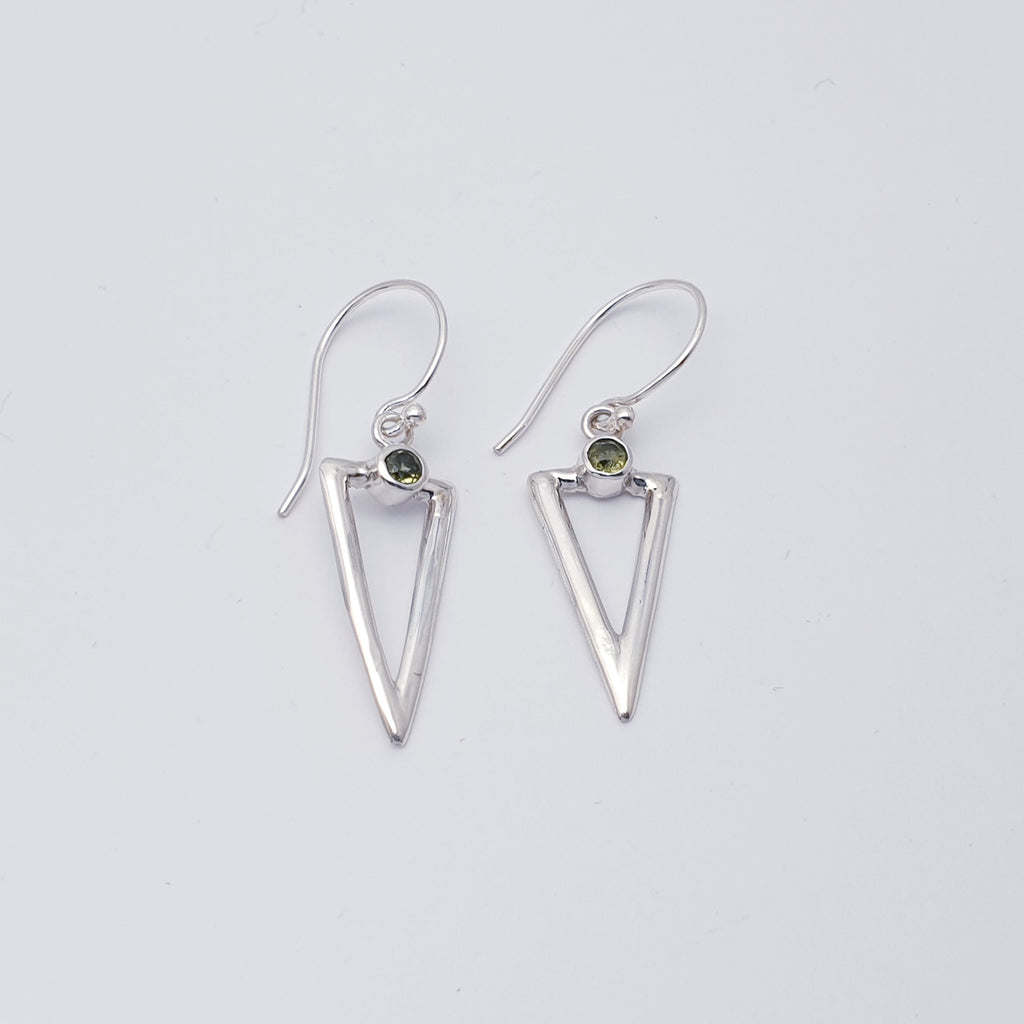 A simple yet unique design, these earrings feature round tabletop cut Peridot stones, which sit above acute triangles hand worked in Sterling Silver. Light, easy to wear and will complement any outfit, these earrings will soon become everyday favourites.