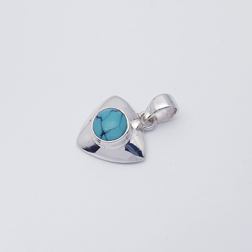 A delicate design, this pendant features a Turquoise stone set in a solid Sterling Silver triangle shape. With a contemporary twist, this pendant will complement any outfit, day or night. 