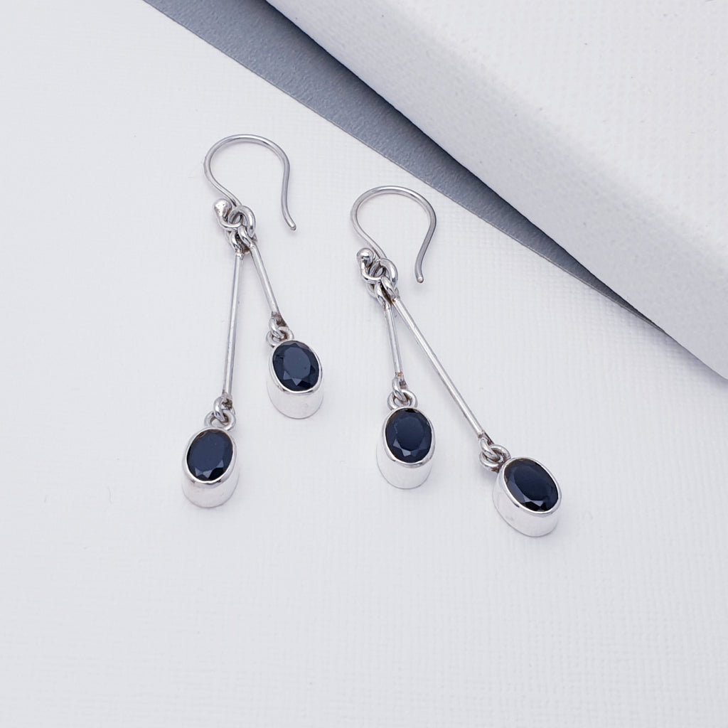 Each earring features two oval, table top cut Onyx stones in simple settings. The stones are attached to two fine Sterling Silver bars, creating a beautiful design with plenty of movement. A contemporary twist on a timeless design, these are bound to be very well received.
