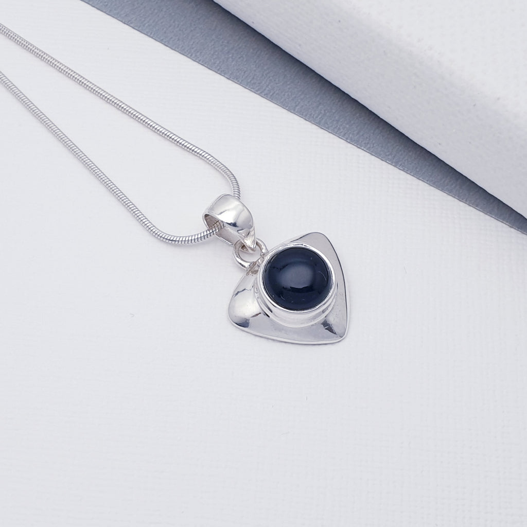 A delicate design, this pendant features an Onyx stone set in a solid Sterling Silver triangle shape. With a contemporary twist, this pendant will complement any outfit, day or night. 