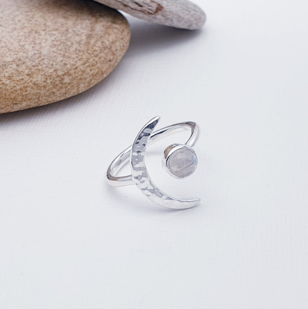 A gorgeous design, this ring features a beautiful cabochon, round Moonstone in a simple setting. To complement a hammered Sterling Silver crescent moon, wraps comfortably around the finger. 