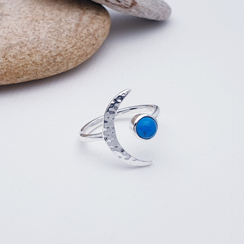 A gorgeous design, this ring features a beautiful cabochon, round Turquoise stone in a simple setting. To complement a hammered Sterling Silver crescent moon, wraps comfortably around the finger. 