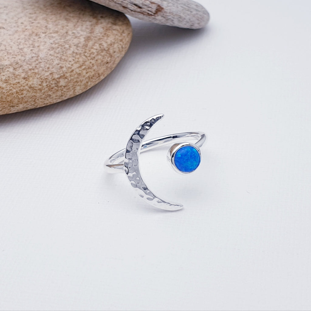 A gorgeous design, this ring features a beautiful cabochon, round Opalite stone in a simple setting. To complement a hammered Sterling Silver crescent moon, wraps comfortably around the finger. 