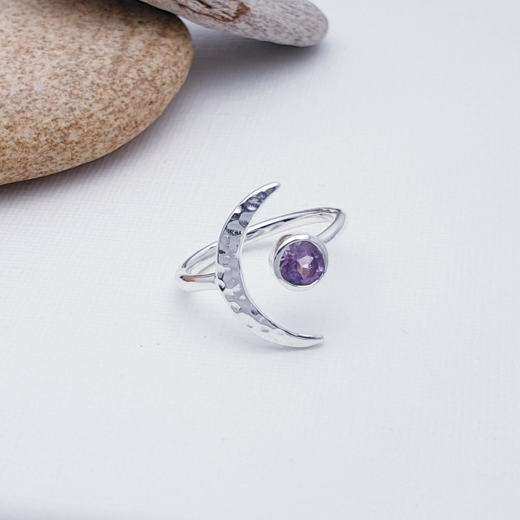 A gorgeous design, this ring features a beautiful cabochon, round Amethyst stone in a simple setting. To complement a hammered Sterling Silver crescent moon, wraps comfortably around the finger. 