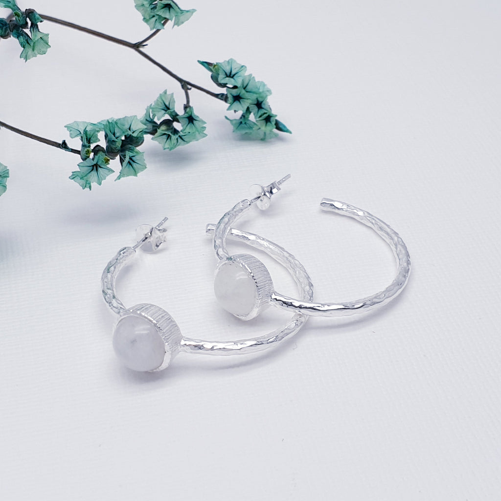 Each earring features a half hoop design with a beautiful, cabochon Moonstone in a Sterling Silver setting. Each hoop has a Sterling Silver hammered effect creating that 'something a little different' we love at Silver Scene. The stud fixing makes these earrings extra secure so you don't need to worry about loosing them.