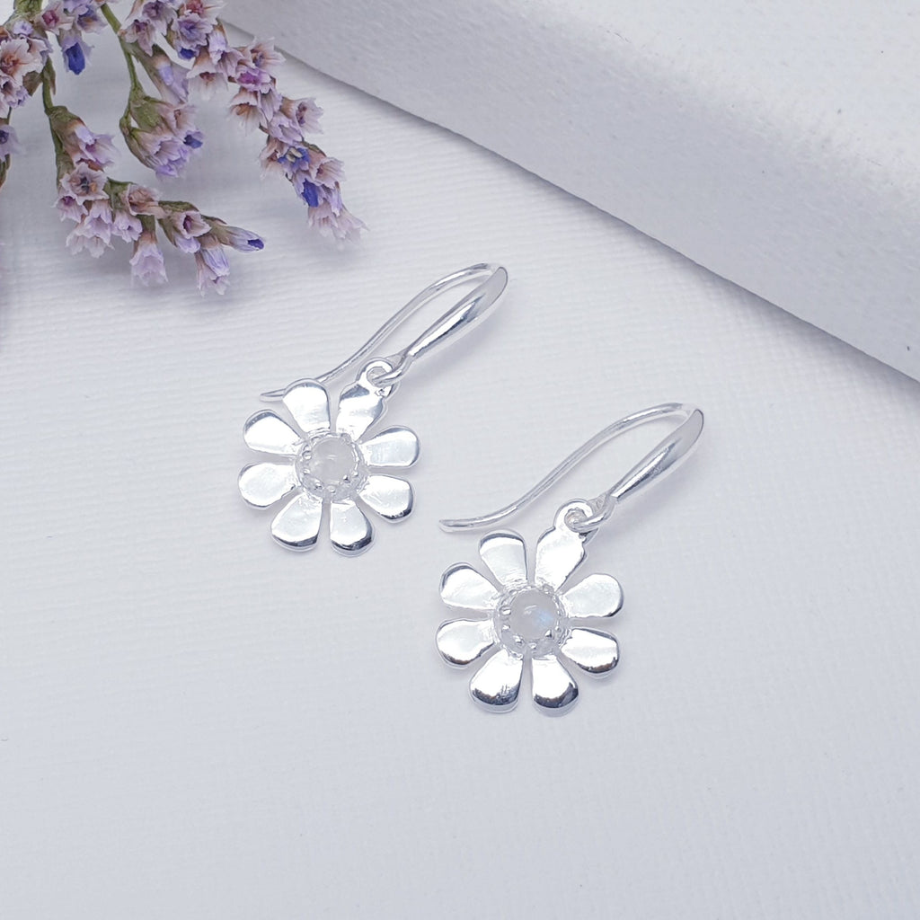 A dainty design, each earring features a round cabochon Moonstone. The Moonstones are highlighted by decorative Silver petals creating a detailed daisy. These earrings will add sparkle and shine to any outfit, you just can't go wrong with this understated pair of studs. 