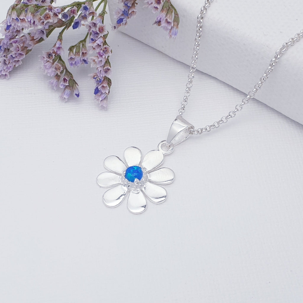 This pendant features a round cabochon Reconstituted Opal. The Opal stone is highlighted by decorative Silver petals creating a detailed daisy.  A beautiful little pendant, this is bound to become an everyday favourite.